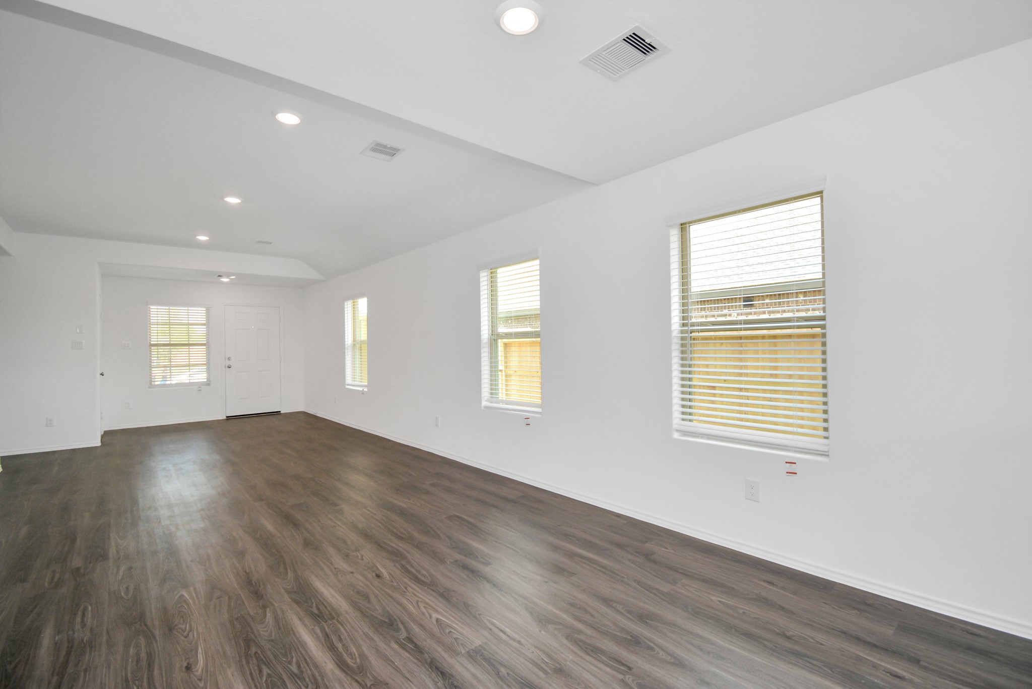 5035 Caledonia Lake Lane Rosharon, TX 77583 - Photo 22 of 37 a view of an empty room with wooden floor and a window