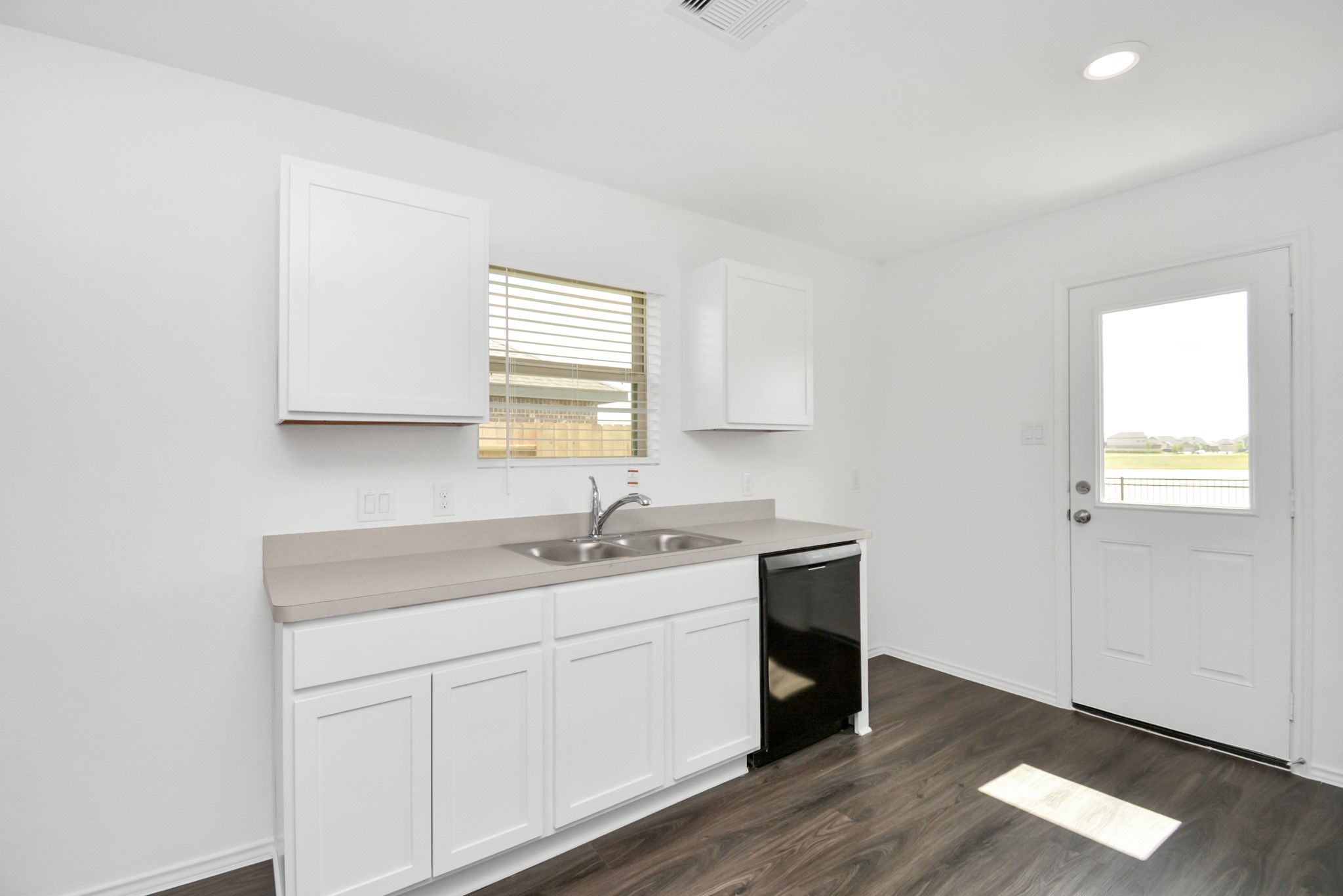 5035 Caledonia Lake Lane Rosharon, TX 77583 - Photo 23 of 37 a kitchen with a sink cabinets and a window