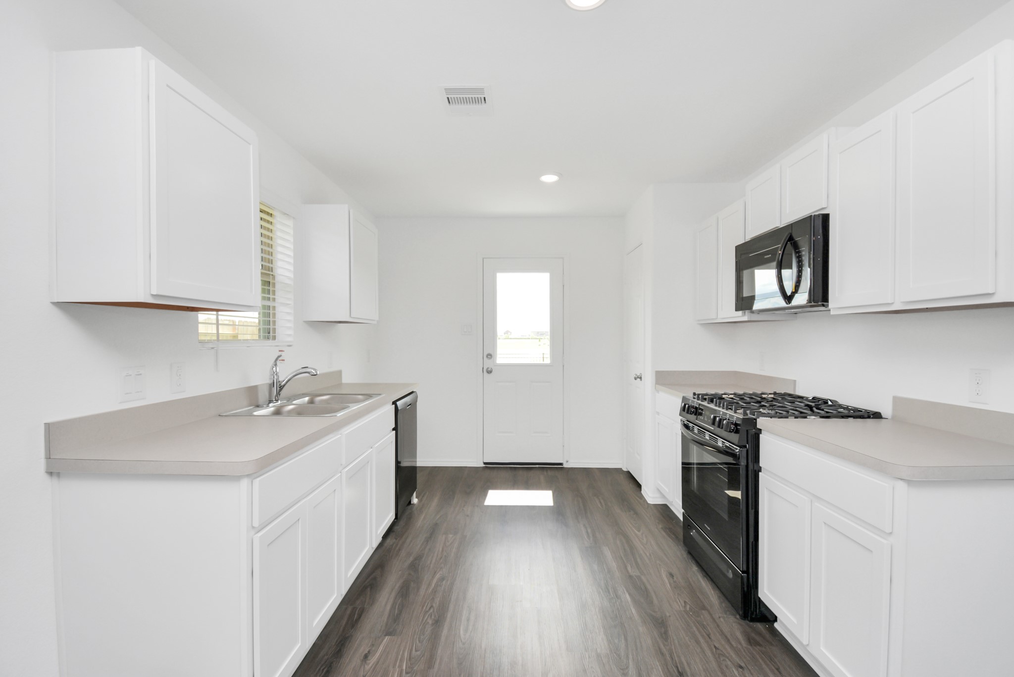5035 Caledonia Lake Lane Rosharon, TX 77583 - Photo 25 of 37 a kitchen with a sink stove and cabinets