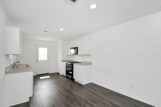 a room with a wooden floor and a window