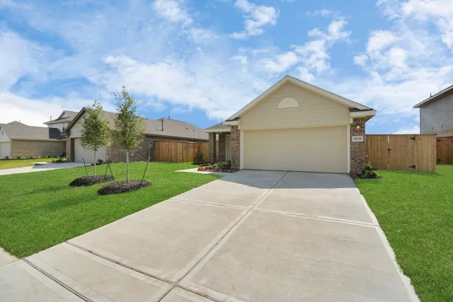 a front view of house with yard and green space