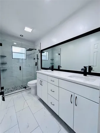 a bathroom with a sink vanity and mirror