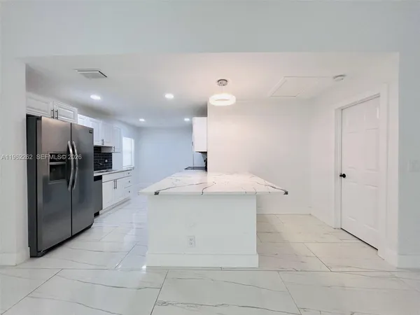 a kitchen with stainless steel appliances granite countertop a sink and a stove top oven