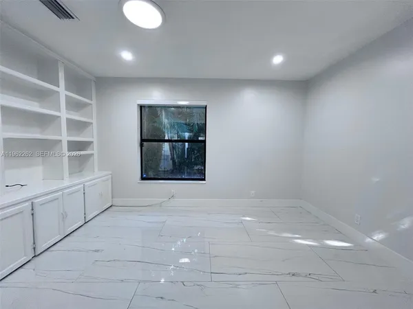 a view of a fireplace with an empty room