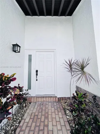 a view of a house with potted plants
