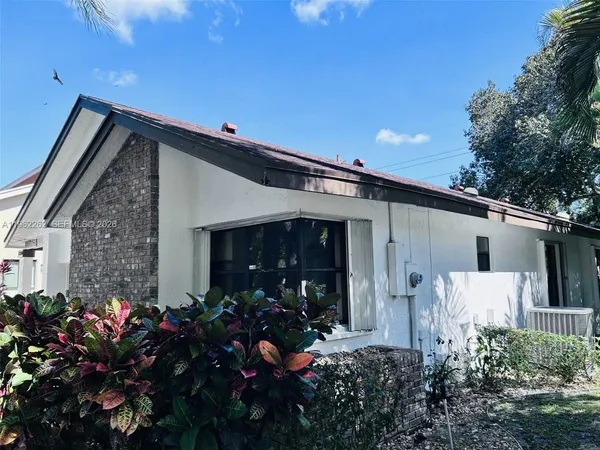 a view of house with a yard and patio