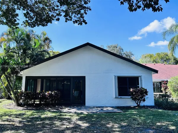 a front view of house with a garden