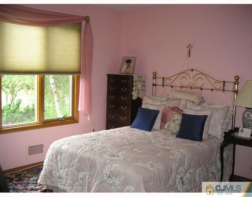 28 Fishel Road Edison, NJ 08820 - Photo 8 of 10 a bedroom with a bed and a window