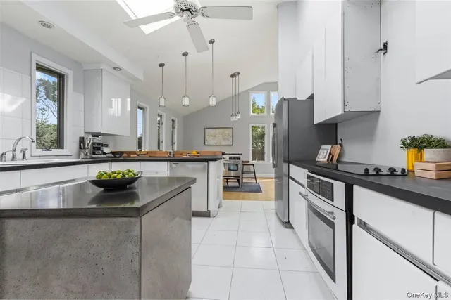 a kitchen with stainless steel appliances granite countertop a refrigerator sink and stove