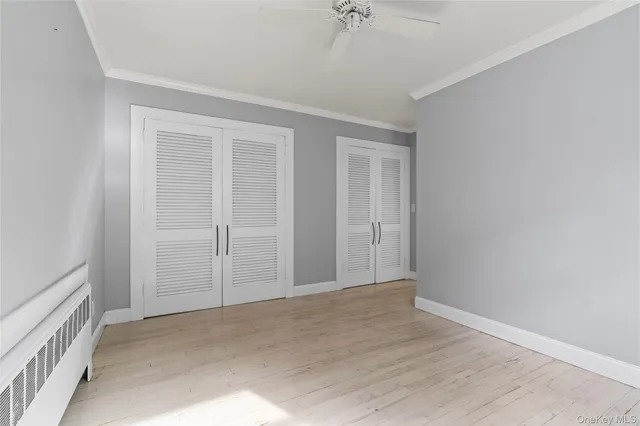 a spacious bedroom with a bed and a window