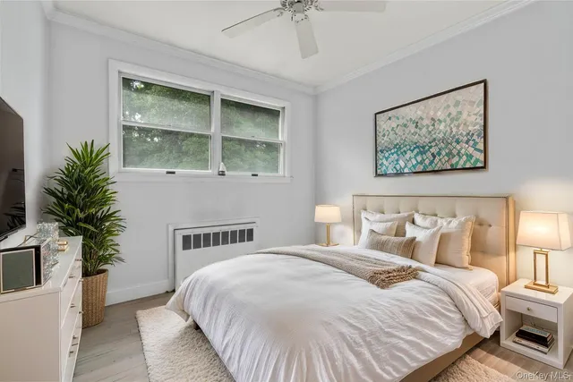 a bedroom with bed and paintings on the wall