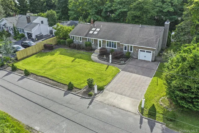 an aerial view of a house with a garden and mountain view