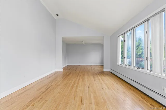 a view of a kitchen with kitchen island stainless steel appliances refrigerator and window