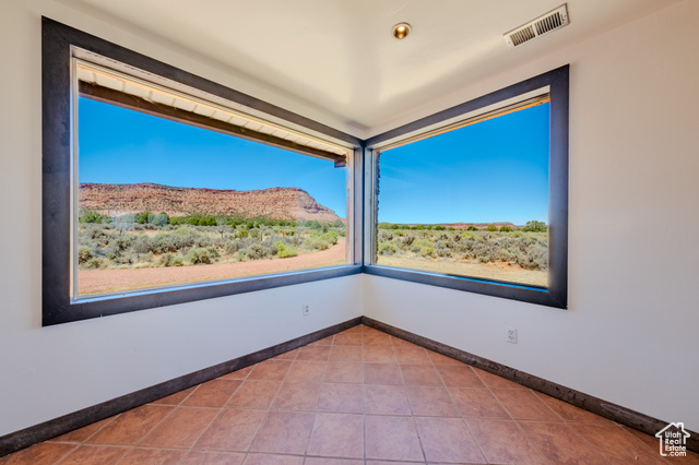 6178 East Zion Road Kanab, UT 84741 - Photo 15 of 48 Spare room featuring a mountain view and tile patterned floors