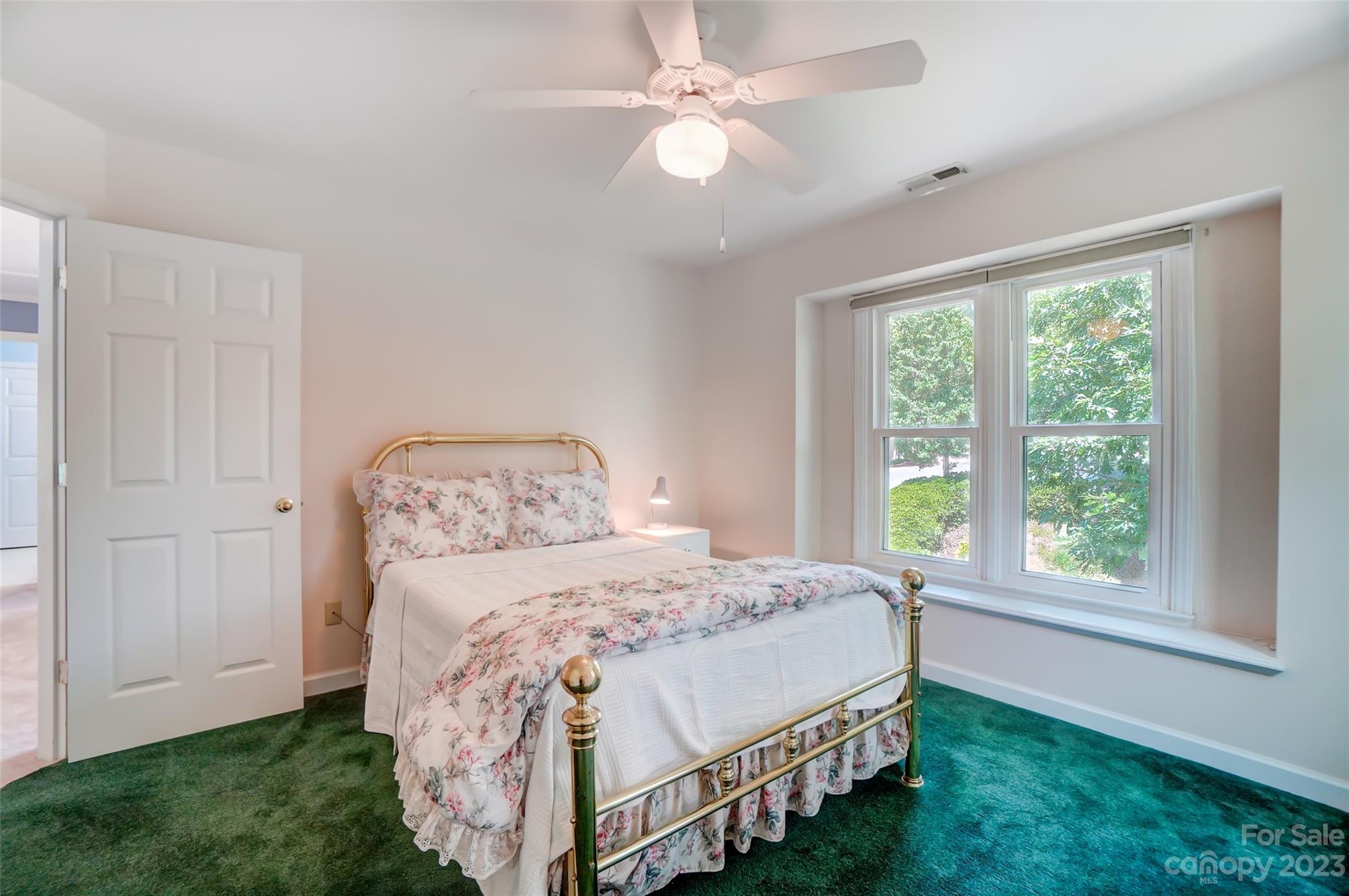 29025 Beaver Run Tega Cay, SC 29708 - Photo 25 of 42 a bedroom with a bed and a chandelier
