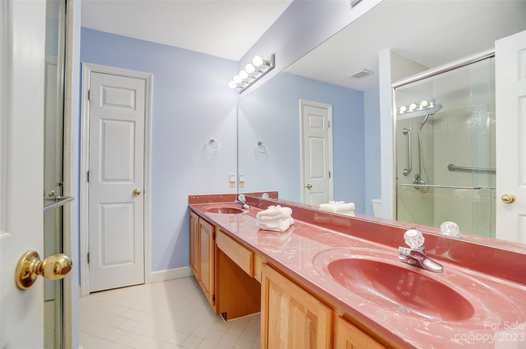 29025 Beaver Run Tega Cay, SC 29708 - Photo 26 of 42 a bathroom with a granite countertop double vanity sink and mirror