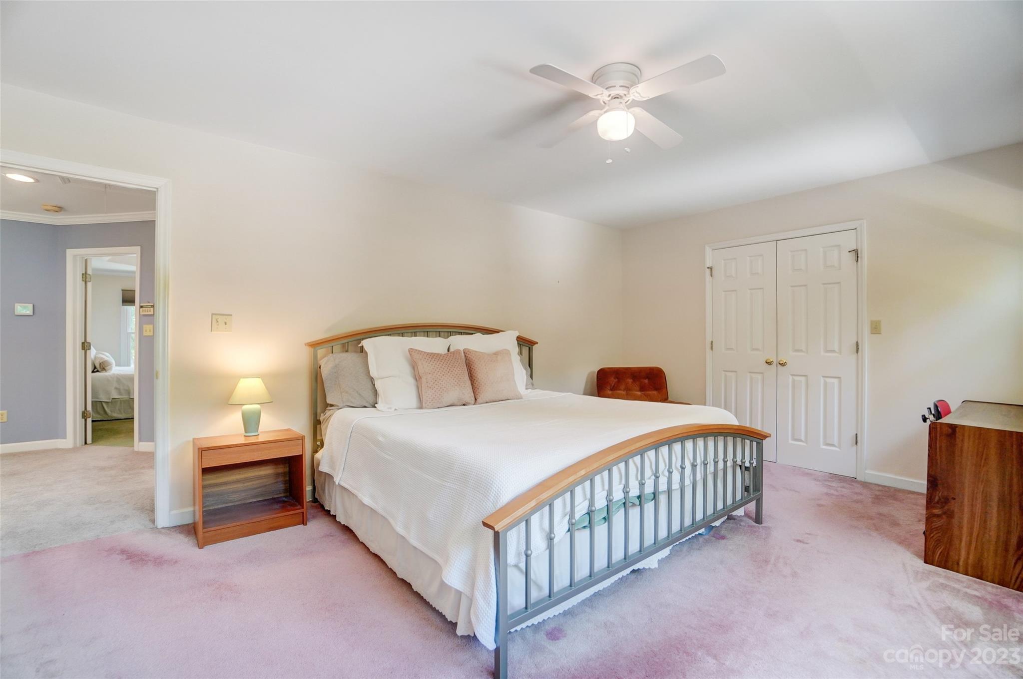 29025 Beaver Run Tega Cay, SC 29708 - Photo 28 of 42 a bedroom with a bed and a chandelier