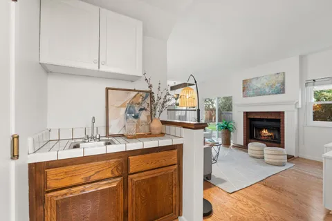 a kitchen with a sink cabinets and a fireplace
