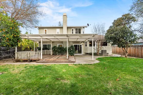 a view of a house with a yard and sitting area