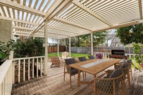 a view of a patio with a table chairs and backyard