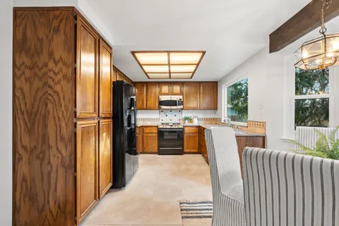 a kitchen with kitchen island wooden cabinets and stainless steel appliances
