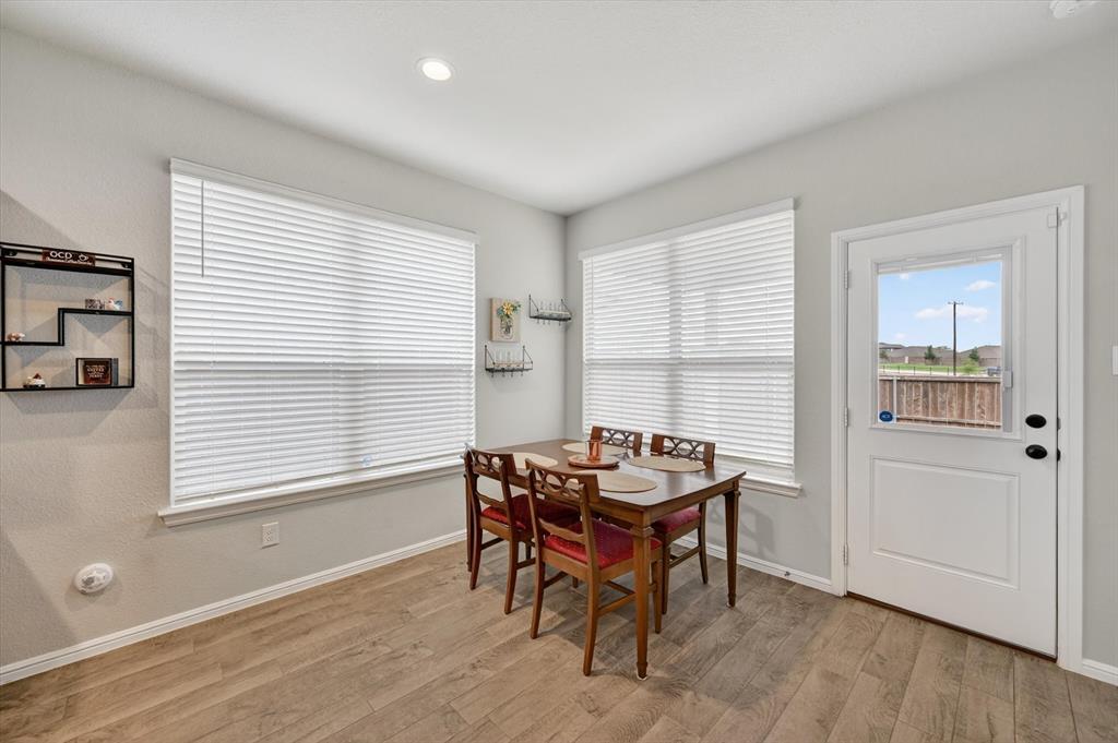 9604 Cherryville Road Fort Worth, TX 76108 - Photo 6 of 40 Dining area featuring wood-finish flooring and two large windows with blinds