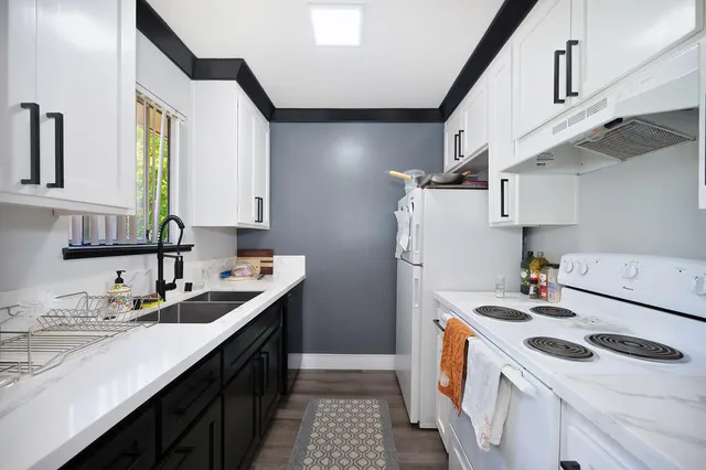 a kitchen with a sink a stove a refrigerator and a sink