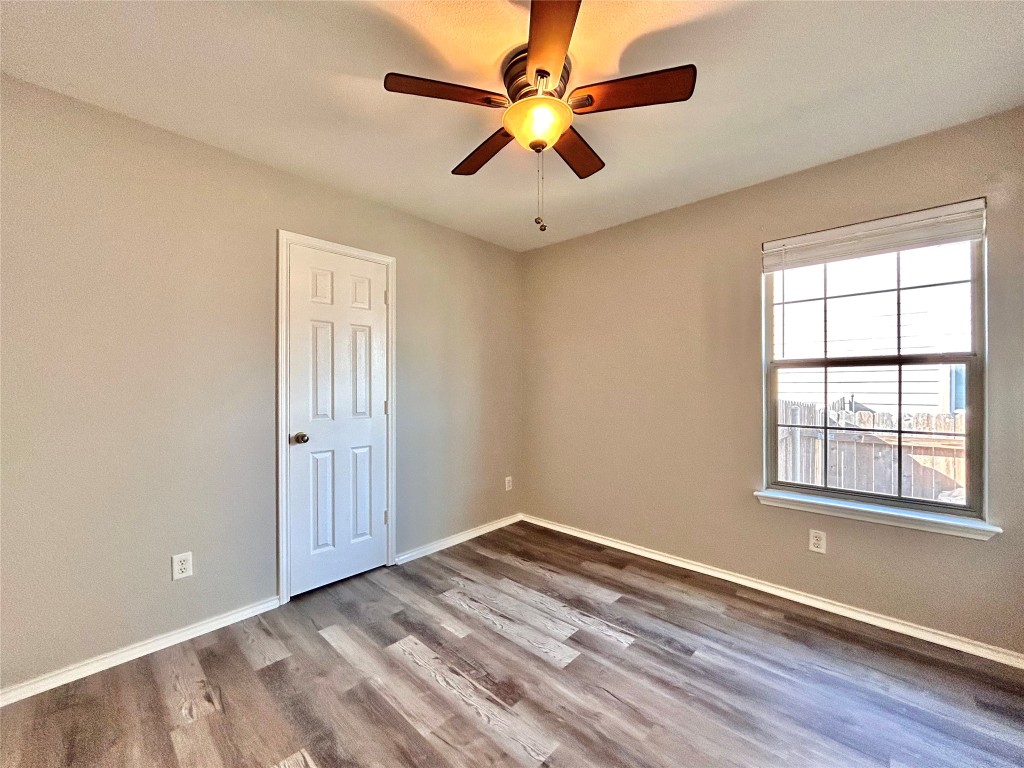2011 Ashberry Trail Georgetown, TX 78626 - Photo 17 of 24 Empty room featuring wood finished floors and a ceiling fan