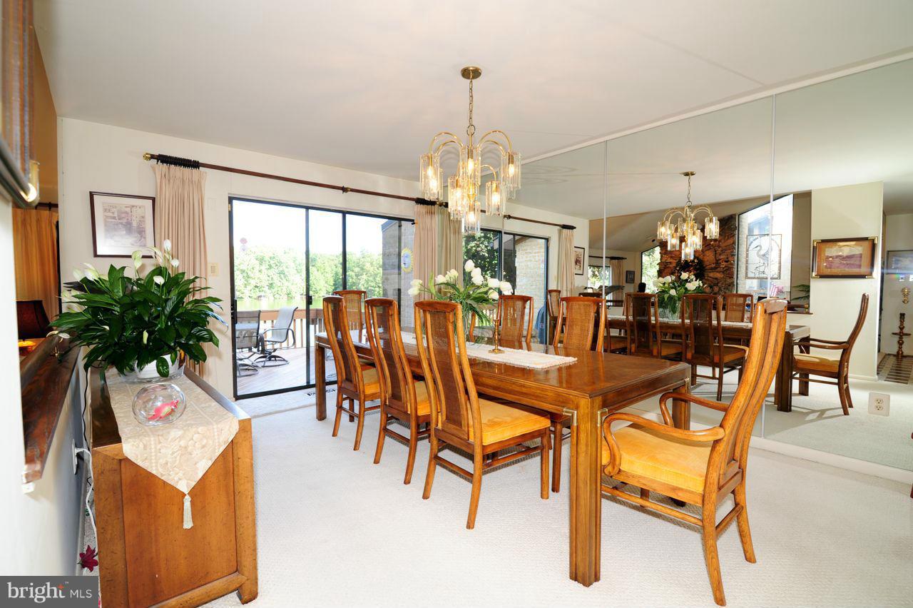 2012 Lakewinds Drive Reston, VA 20191 - Photo 11 of 26 a dining room with furniture potted plants and wooden floor