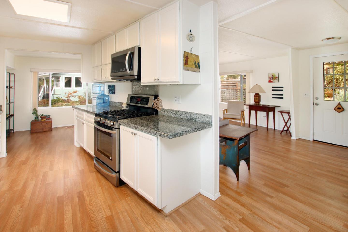 270 Hames Road, Unit 38 Corralitos, CA 95076 - Photo 11 of 35 a kitchen with granite countertop wooden floors and stainless steel appliances