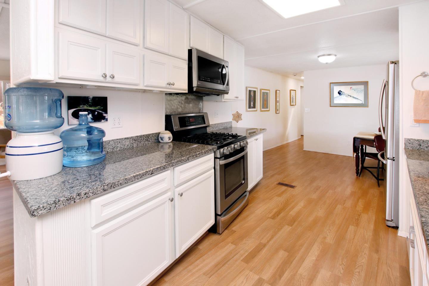 270 Hames Road, Unit 38 Corralitos, CA 95076 - Photo 12 of 35 a kitchen with stainless steel appliances granite countertop a stove a sink and a refrigerator
