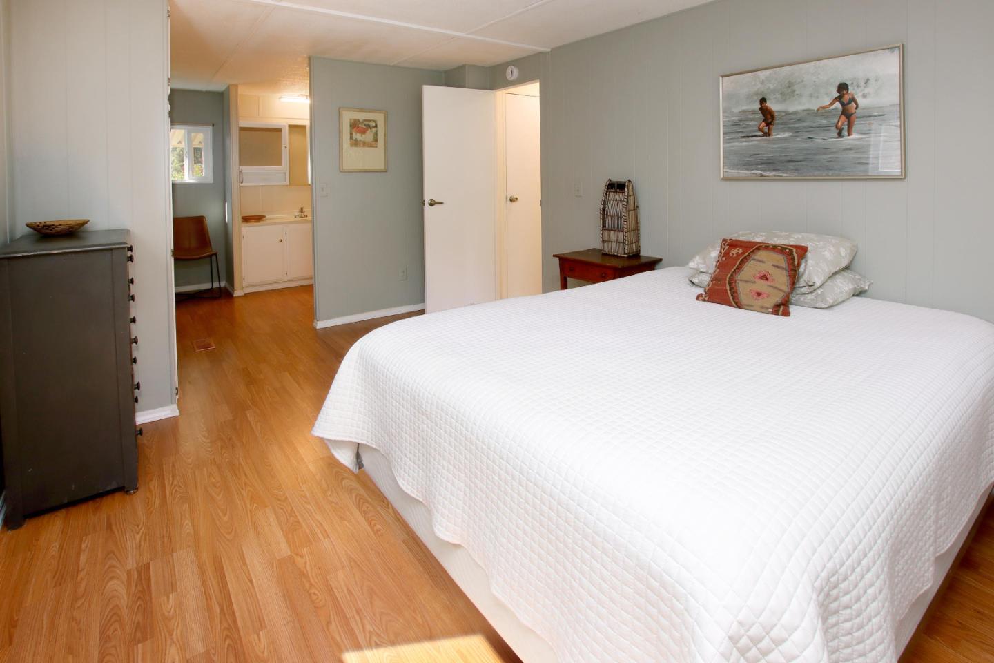 270 Hames Road, Unit 38 Corralitos, CA 95076 - Photo 15 of 35 a spacious bedroom with a bed and painting on the wall
