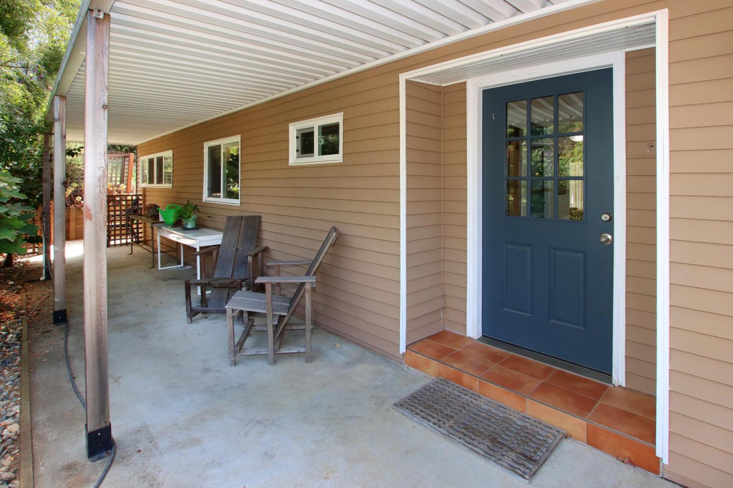 270 Hames Road, Unit 38 Corralitos, CA 95076 - Photo 4 of 35 a view of a patio with table and chairs and wooden fence