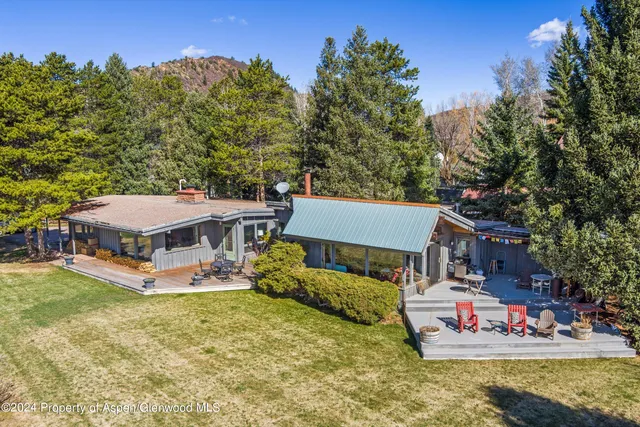 an aerial view of a house with swimming pool garden and outdoor seating