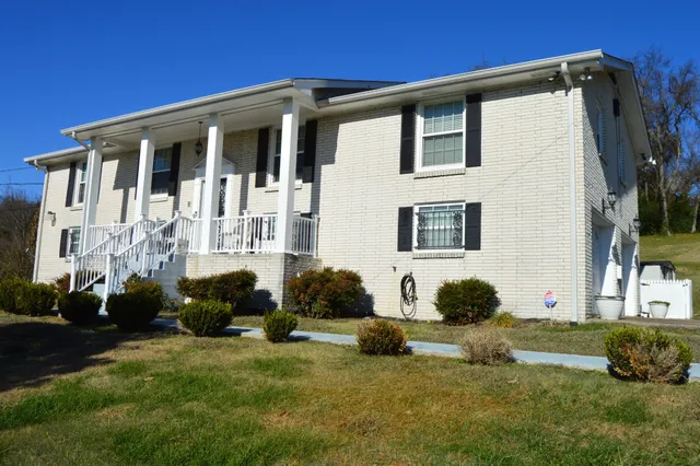 a front view of a house with a yard