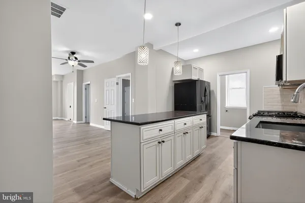 a large kitchen with cabinets a sink and a stove