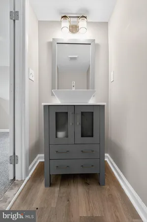 a view of an empty room with wooden floor and cabinet