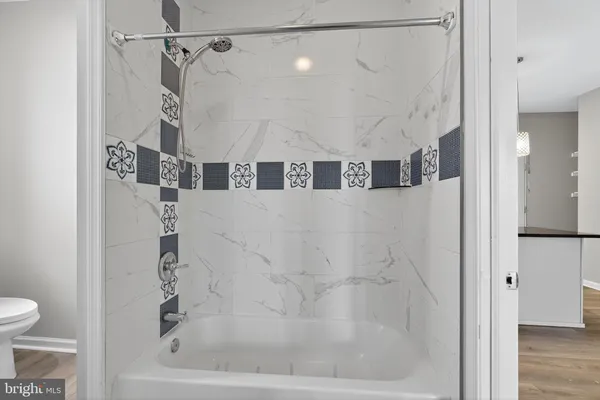 a bathroom with a bathtub and a shower