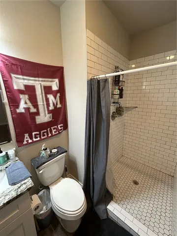a white toilet sitting next to a bathroom sink