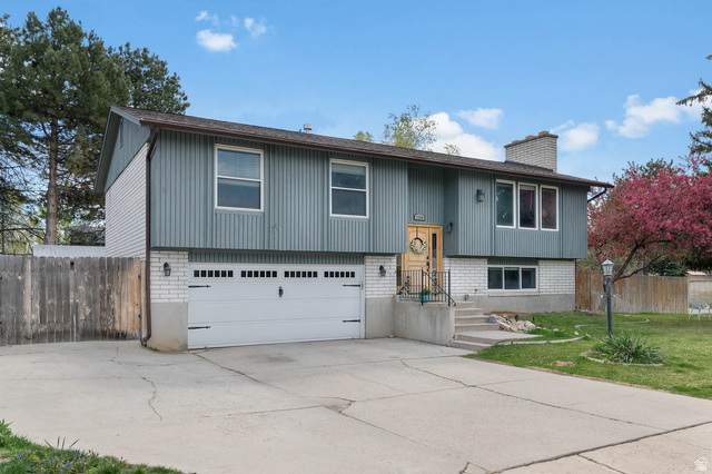 1758 Abbedale Lane Sandy, UT 84092 - Photo 1 of 1 Raised ranch with a garage, concrete driveway, a chimney, and brick siding