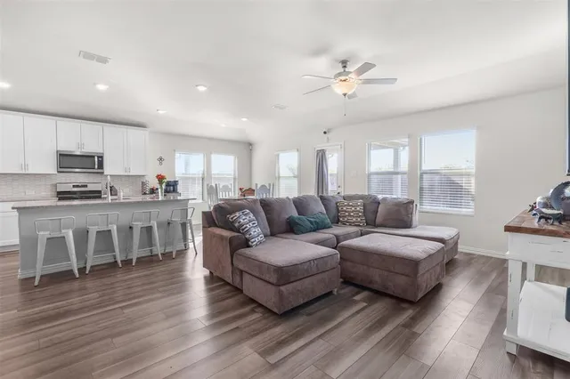 a living room with furniture and kitchen view