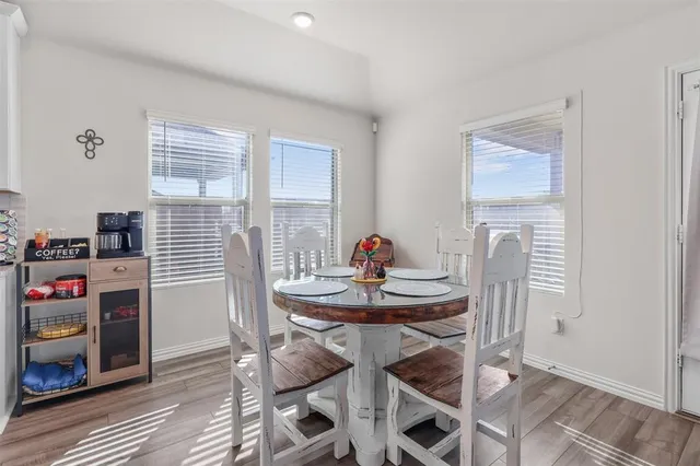 a view of a dining room with furniture and window
