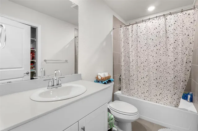 a bathroom with a sink toilet and a mirror