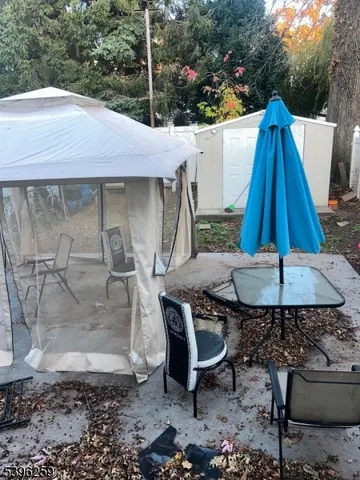 a backyard of a house with yard fountain and outdoor seating