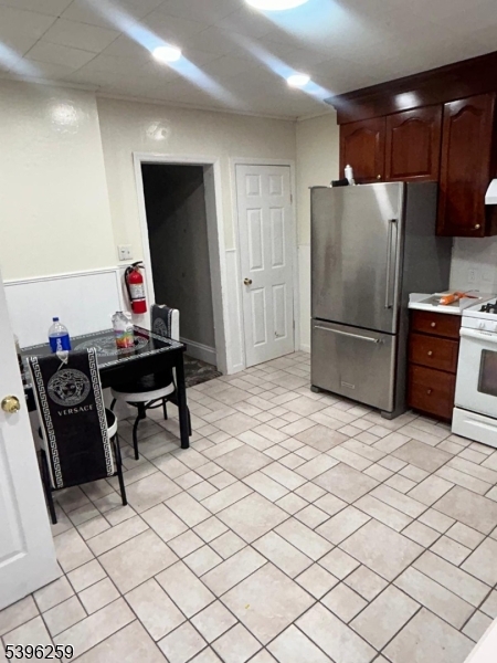 114 Ely Street Elizabeth, NJ 07202 - Photo 5 of 13 a kitchen with stainless steel appliances a refrigerator and a stove top oven