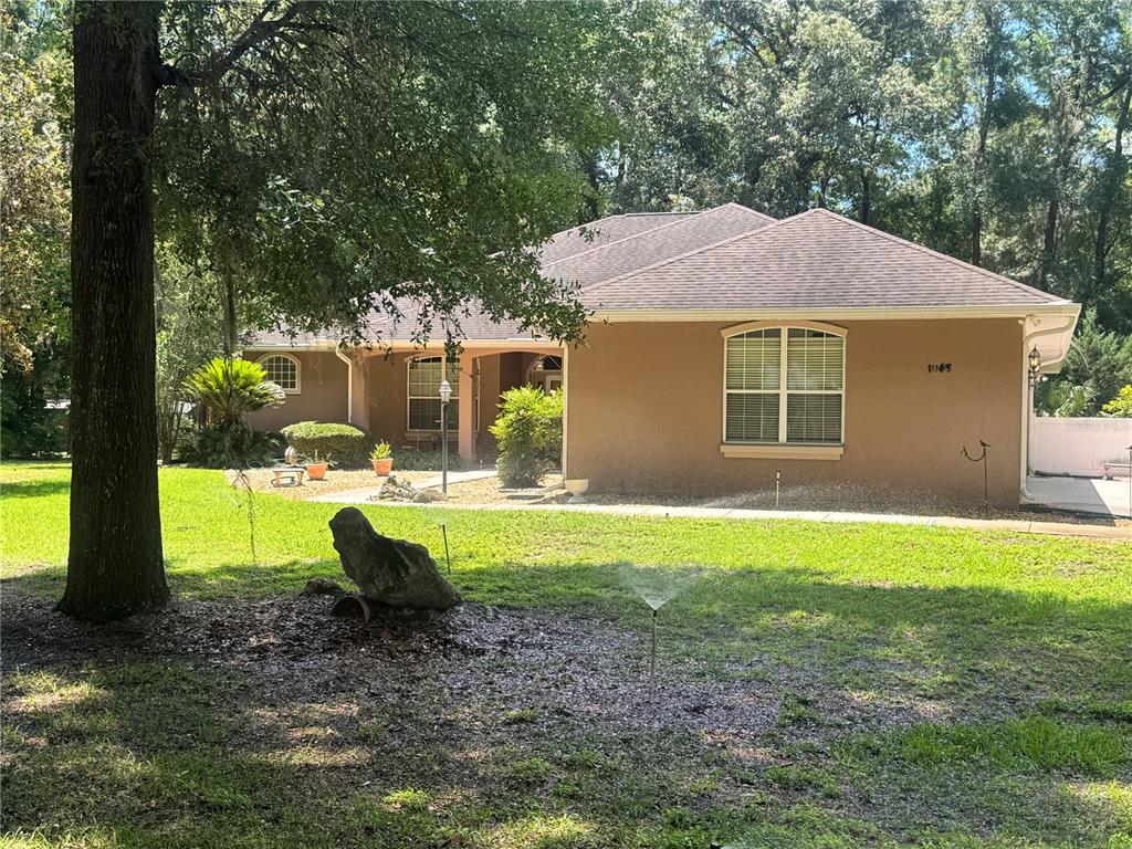 11145 Northwest 17th Court Road Ocala, FL 34475 - Photo 13 of 59 a view of a house with backyard and a tree