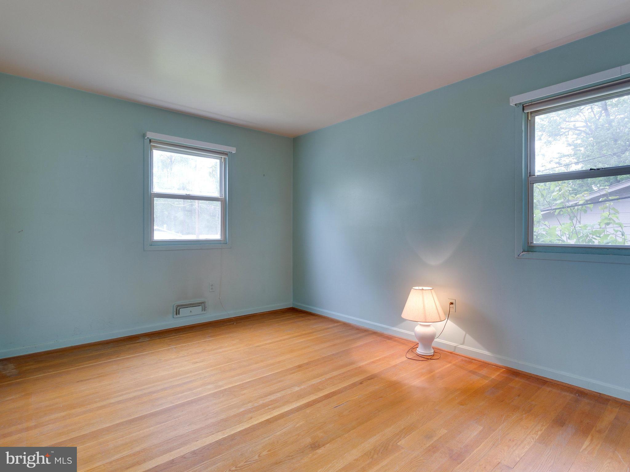 8207 Old Oaks Drive Springfield, VA 22152 - Photo 15 of 30 a view of empty room with wooden floor and window