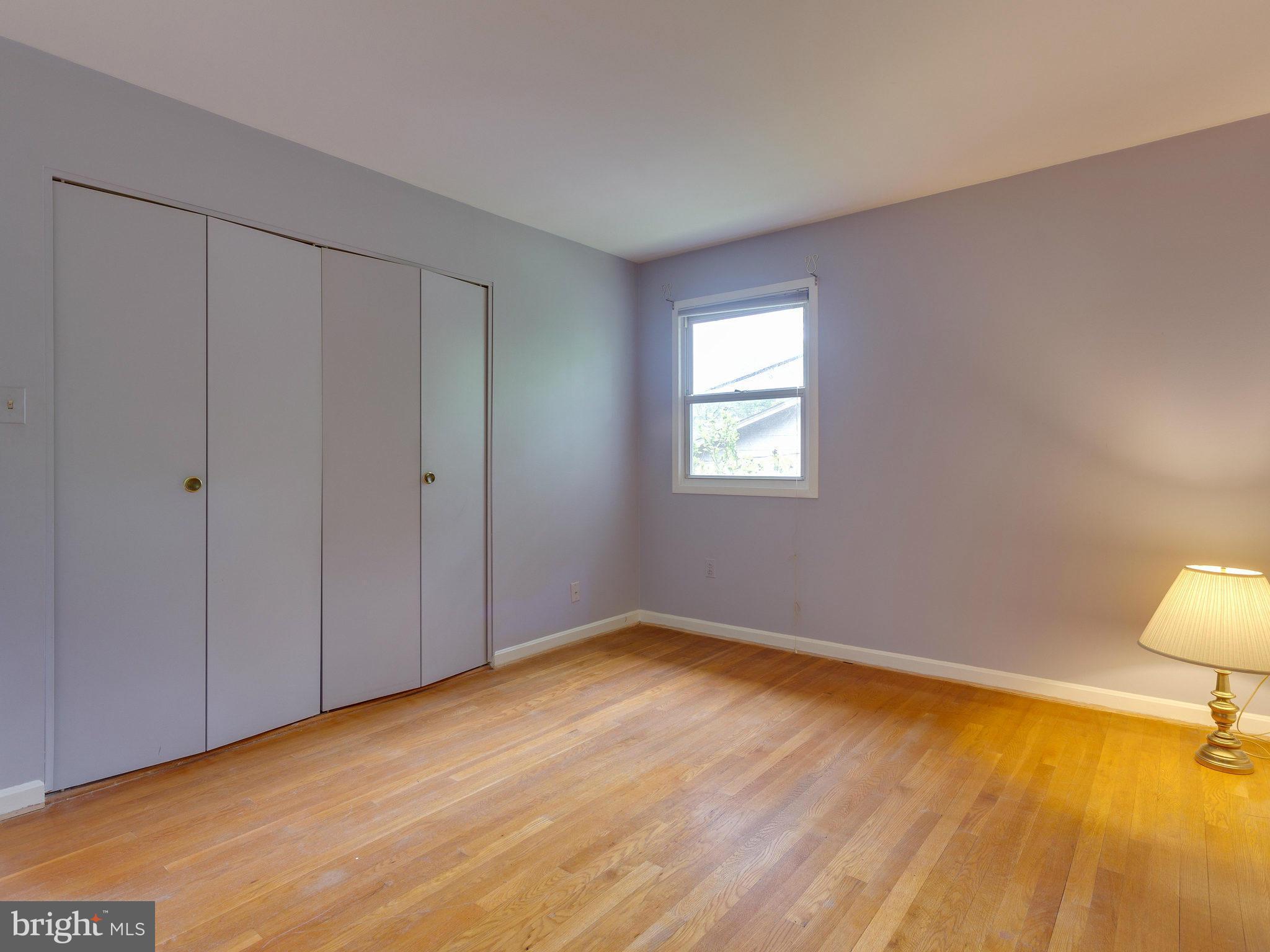8207 Old Oaks Drive Springfield, VA 22152 - Photo 20 of 30 a view of an empty room with wooden floor and a window