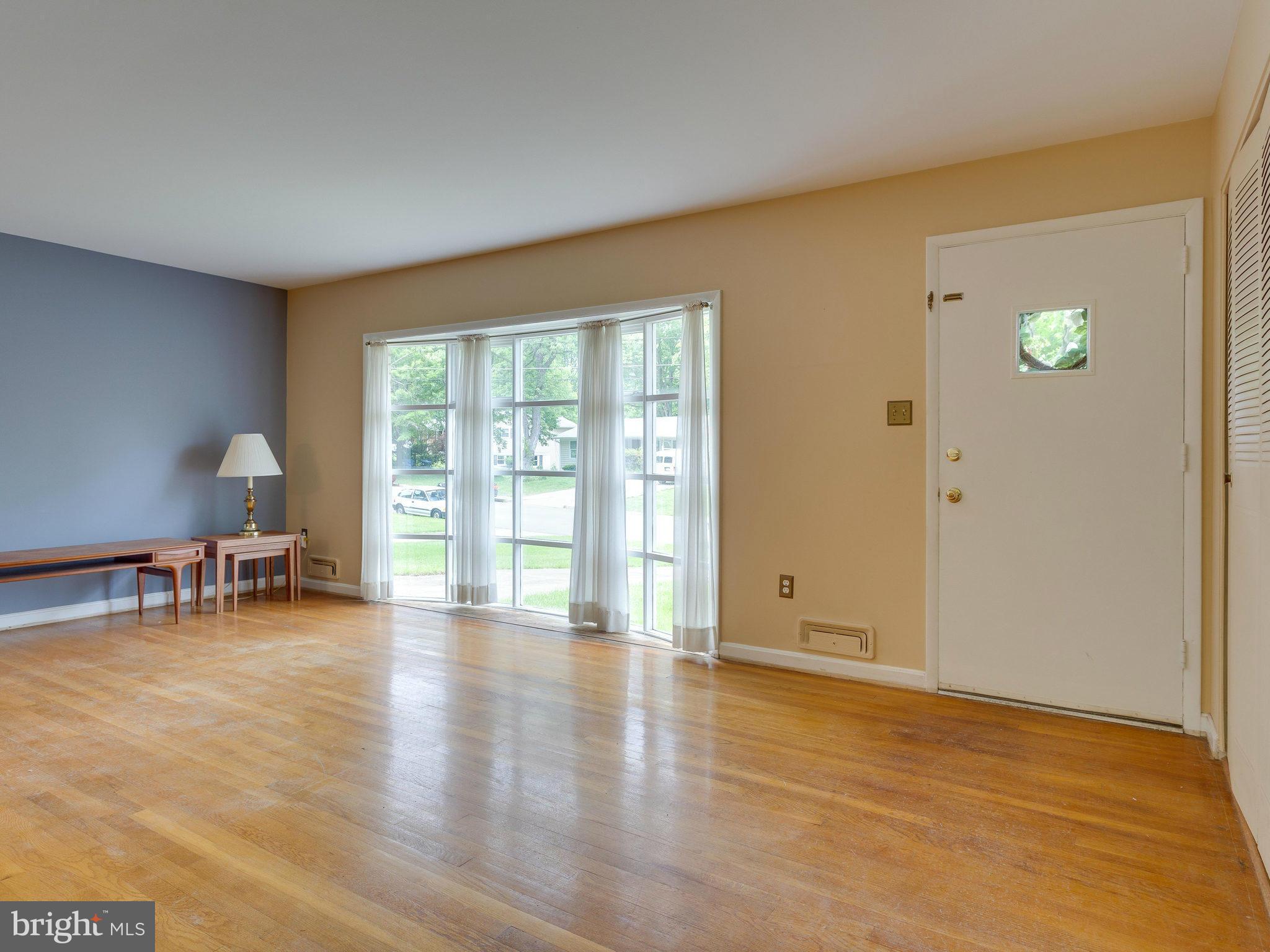 8207 Old Oaks Drive Springfield, VA 22152 - Photo 3 of 30 a view of empty room with window and wooden floor