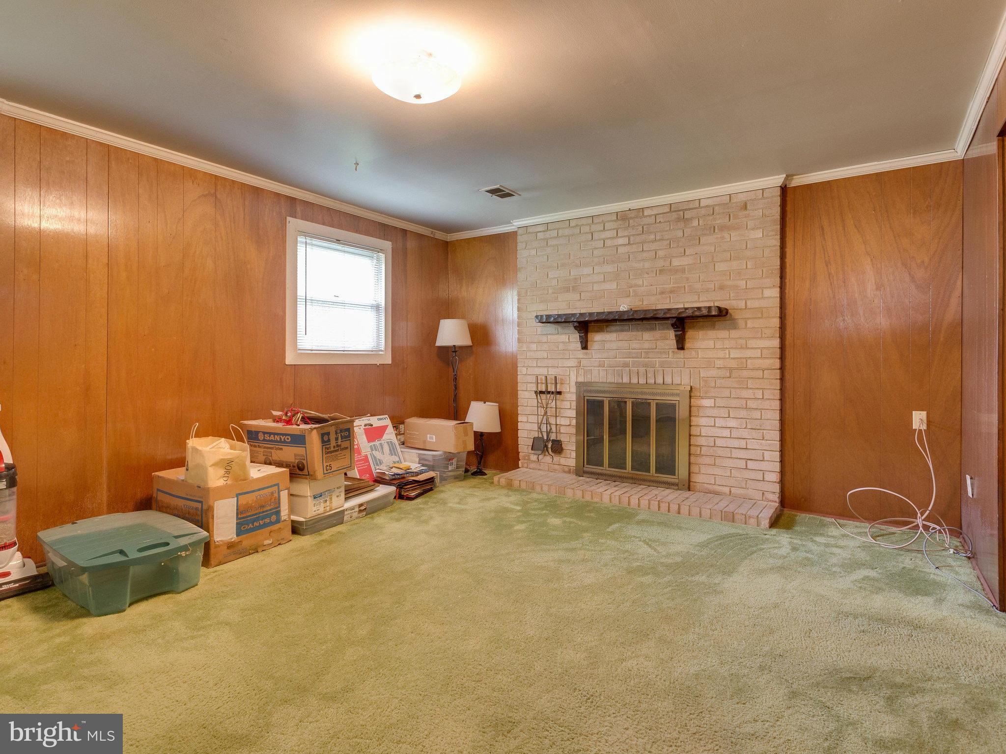 8207 Old Oaks Drive Springfield, VA 22152 - Photo 21 of 30 a living room with furniture and a fireplace